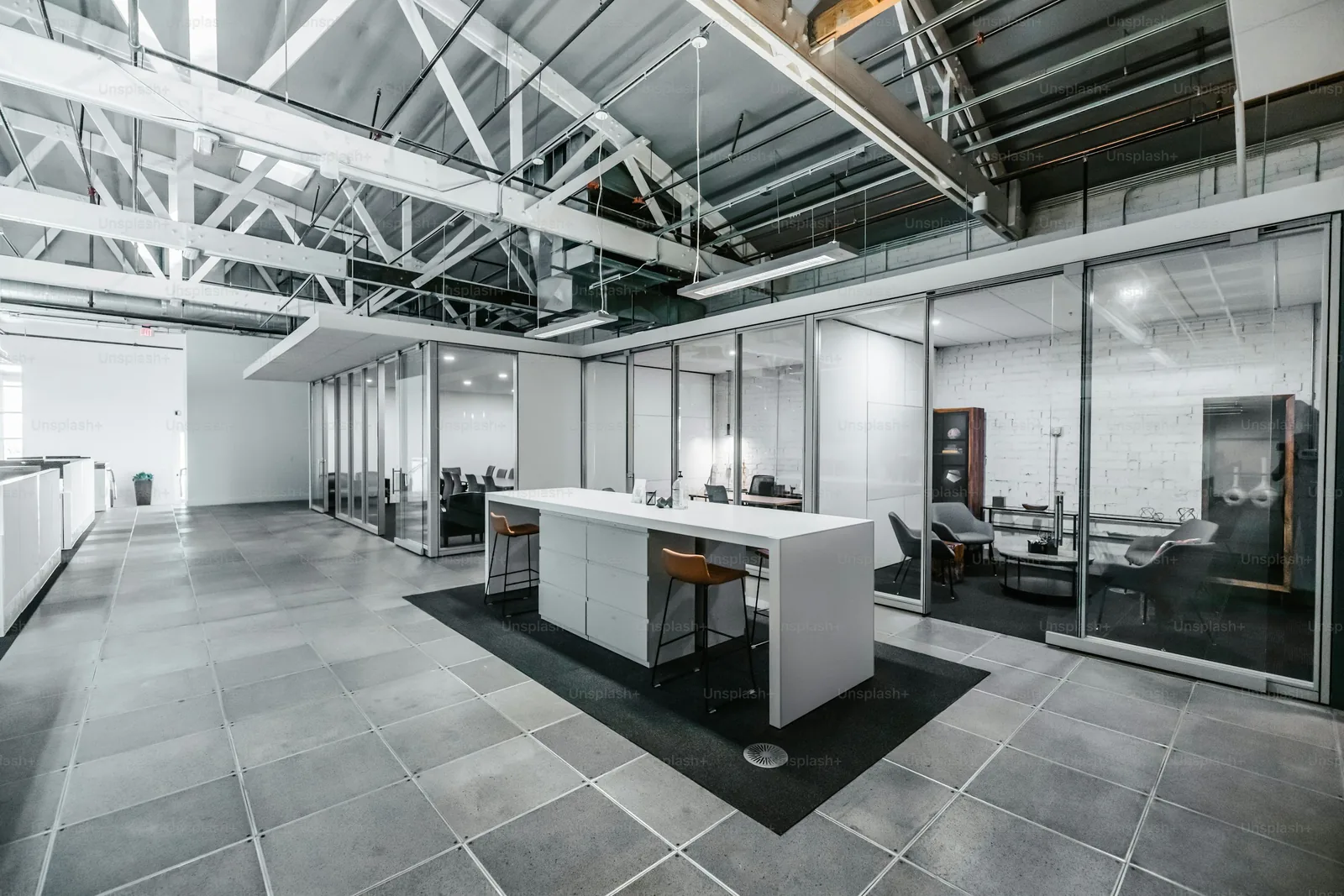 Illustrative open commercial interior with exposed structure and large windows